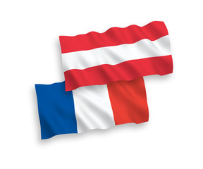 National vector fabric wave flags of France and Austria isolated on white background. 1 to 2 proportion.