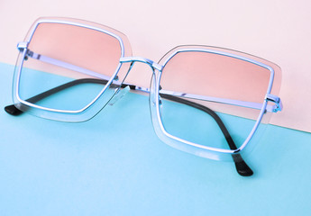 Stylish sunglasses on colorful background.
