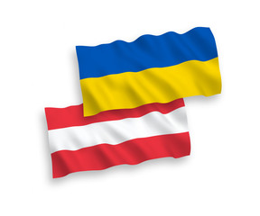 National vector fabric wave flags of Austria and Ukraine isolated on white background. 1 to 2 proportion.