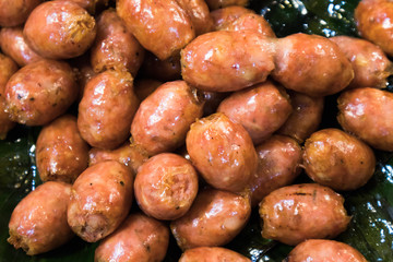 Close up of Thai Isaan style sausages on banana leaf