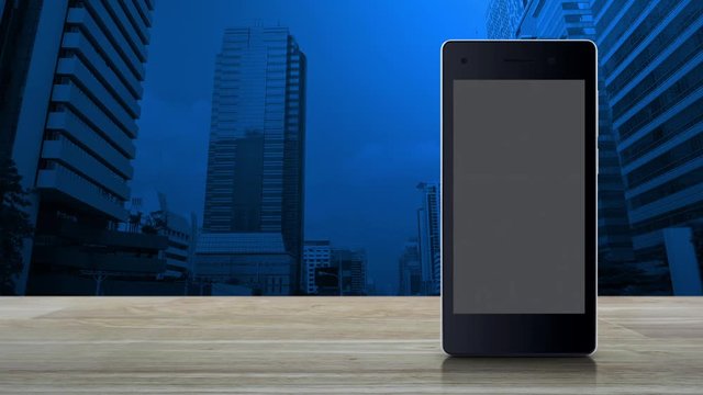 cctv camera flat icon on modern smart mobile phone screen on wooden table over office city tower and skyscraper, Business security and safety online concept