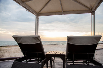 Sunset with empty beach chairs