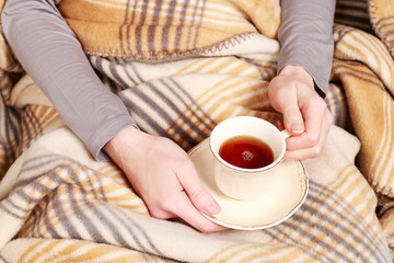 Woman holding a cup of tea.