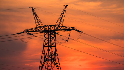Power line pole on the background of sunset and beautiful sky © StockMediaSeller