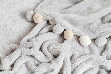 Soft grey blanket with pompoms