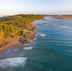 Beautiful aerial image of a seaside village with small beach and gentle blue waves