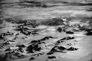 Aerial view of Greenland mountain ranges in black and white
