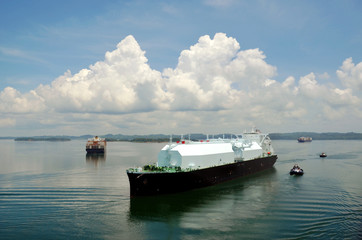 LNG tanker ship transiting through Panama Canal on beautiful sunny day.