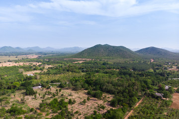 Fototapeta na wymiar Drone shot aerial view scenic landscape of agriculture farm against mountain and nature forest