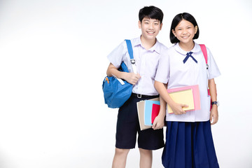 Obraz premium Two asian smiling school kids with colorful stationery,