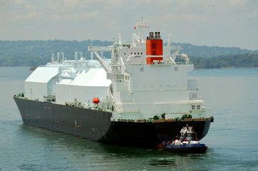 LNG tanker ship transiting through Panama Canal on beautiful sunny day.