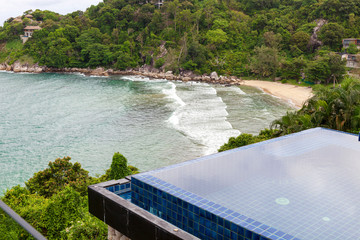 Swimming pool overlooking view andaman sea mountains and blue sky background,summer holiday background concept