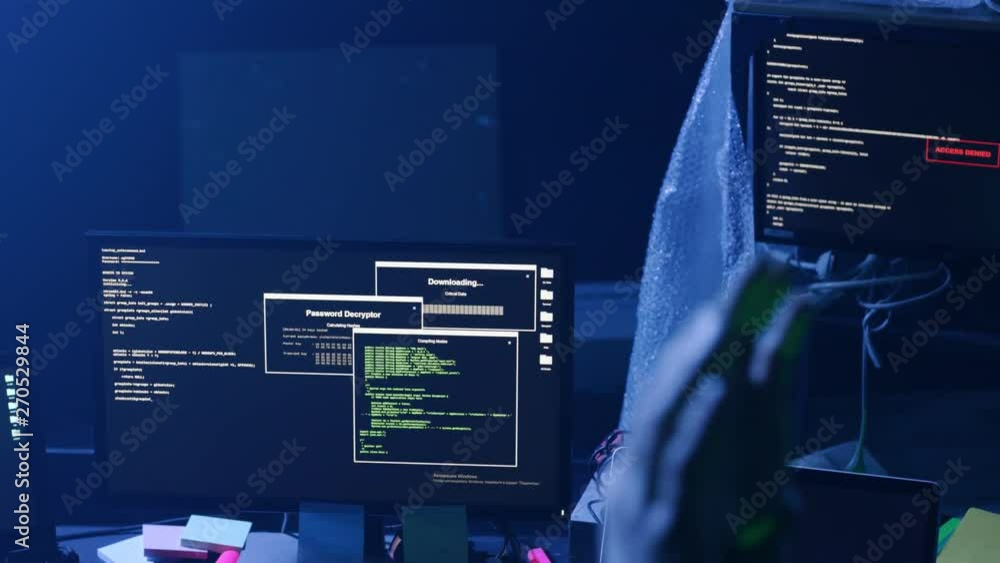 Aufkleber view of hacker�s workplace with multiple displays in smoky room. close-up of male hacker�s hands in 
