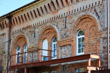 Facade made of red bricks. Brick facade of an old hydroelectric power plant.