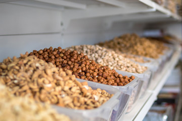 peanuts on the store shelves. different varieties of nuts.