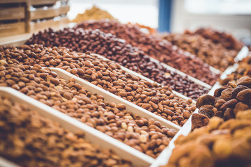 nuts on the store shelves. different varieties of peanuts and almonds.