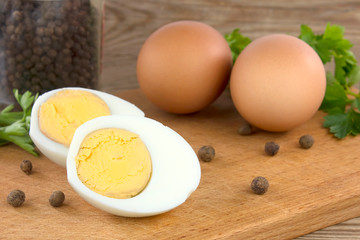 Sliced boiled eggs, with parsley leaves. Cooking a salad with boiled eggs.
