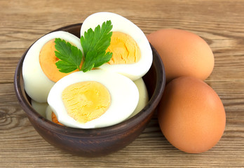 Sliced boiled eggs, with parsley leaves. Cooking a salad with boiled eggs.