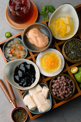 Grass jelly and pudding in a wooden dish