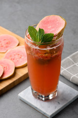 Guava oolong tea with mint leaf in a clean glass