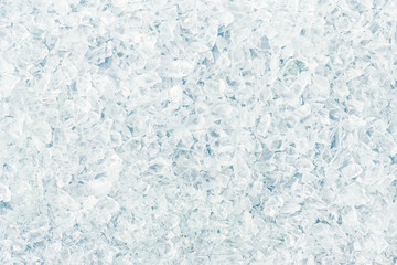 Texture of shattered small white glass fragments. Background of sharp glass pieces ready to be...
