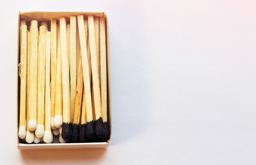 Black and white matches inside the box. Opposition and standoff concept. Copyspace on the right side for design and designers. Dualism and dual nature conception. Yin and yang symbolism.