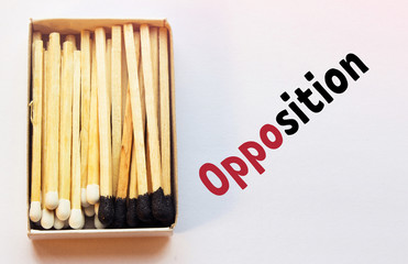 Black and white matches inside the box. Opposition and standoff concept. Black spot and illustration phrase on the right side. Dualism and dual nature conception. Yin and yang symbolism.
