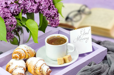 Breakfast. A lilac tray with a cup of coffee and bagels (croissants) and a card for text and an awesome sprig of lilacs.