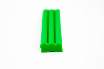Green plasticine on white background