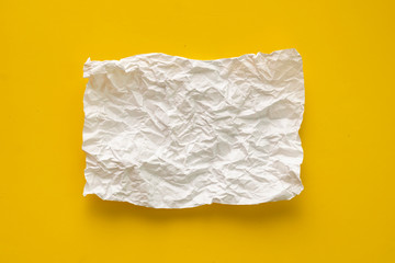 Obraz premium flat lay crumpled white paper sheet isolated on the table, background texture and copy spaces