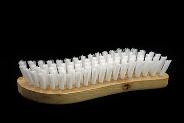 wooden scrubbing brush isolated on black background