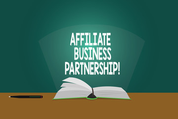 Conceptual hand writing showing Affiliate Business Partnership. Business photo showcasing Intercompany relationship to promote product Color Pages of Book on Table with Pen and Light Beam Glaring