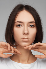 Portrait of a beautiful woman in a white T-shirt and with medium short hair. Studio photo session
