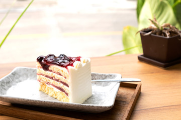 Blue berry cake on a wooden tray.