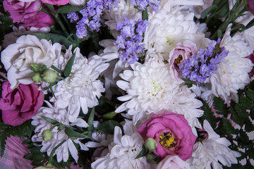 A modern, beautiful floral bouquet on a purple background. White chrysanthemums, pink roses and dried flowers. Background for birthday card, valentine's day, mother's day. Romantic invitation