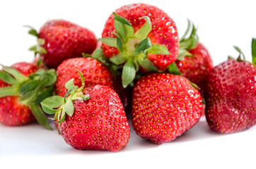 Fototapeta na wymiar lots of strawberries close up on white background