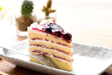 Blue berry cake on a wooden tray.