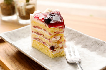 Blue berry cake on a wooden tray.