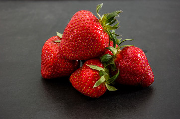tasty strawberries on a black background