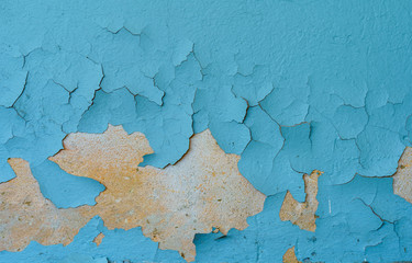 The old cracked blue paint on a wall surface
