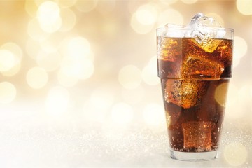 Glass of cola with ice cubes isolated on white background