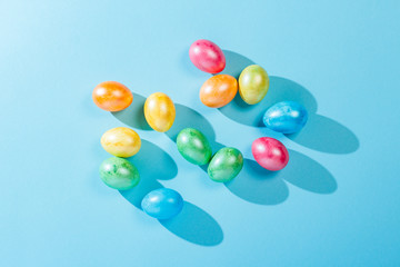 Easter eggs on a blue background. Easter celebration concept. Flat lay, top view