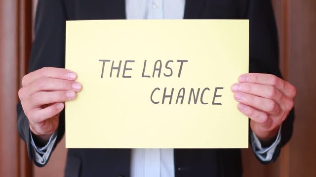 Holding "The last chance" inscription