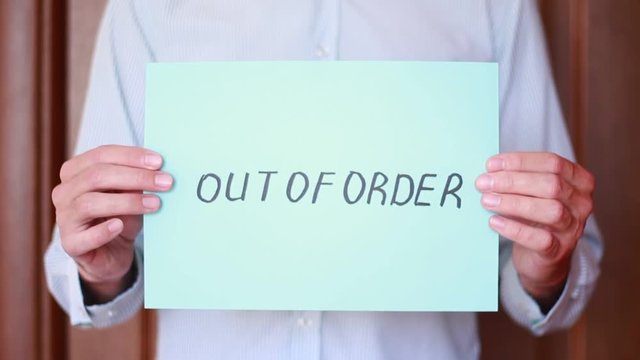 Holding "Out of order" inscription