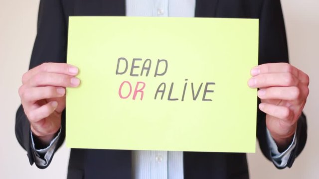 Holding "Dead or Alive" inscription