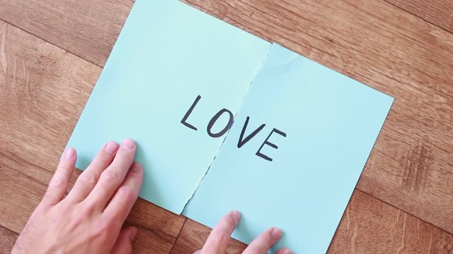 "Love" inscription putting pieces of paper together