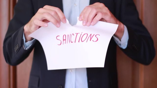 Inscription "Sanctions" ripping up