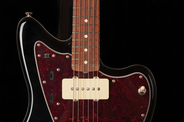 Close up of single coil and controls and  3 way pickup switch on black electric guitar © patrikslezak