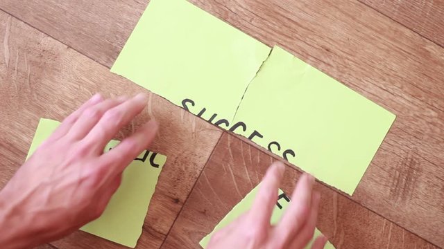 Putting torn pieces of "Success" inscription together