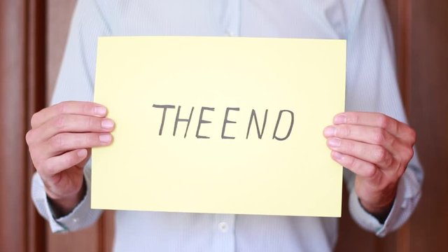 "The End" inscription in male hands